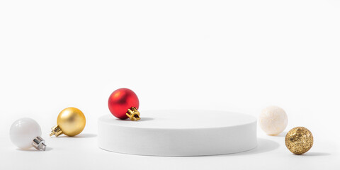 Cosmetic background for Christmas and winter holiday. White podium and christmas balls on white...