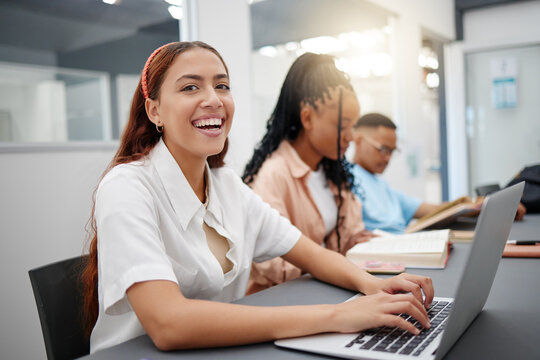 University, internet and student typing notes on laptop with smile at a table in a classroom of school. Portrait of a girl in college learning education in lecture and happy about campus wifi for pc
