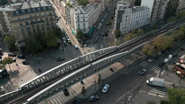  Aerial tilt-up reveal over metro bridge in Cambronne square and cityscape, Paris
