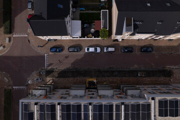 Solar panels on apartment complex in Noorderhaven neighbourhood seen from above. Aerial top down real estate modern energy neutral build architecture.