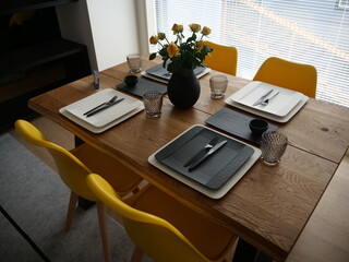 Modern table setting on a wooden table in a beautiful home at the Housing fair 2022, Naantali, Finland
