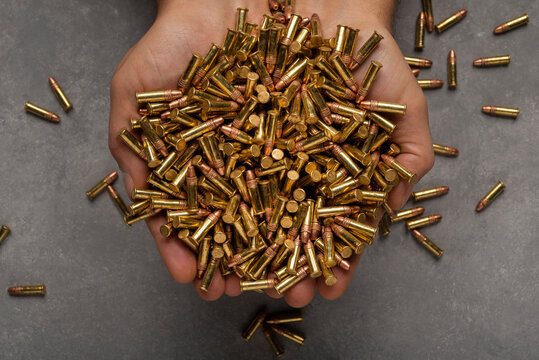 22lr, rimfire  cartridges in male hands.