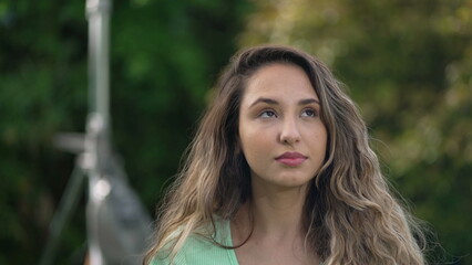 Naklejka premium One hopeful hispanic young woman looking up at sky with FAITH. Spiritual South American female person 2