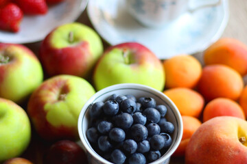 Various healthy seasonal food arranged on wooden background. Selective focus.