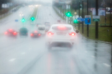 blurred road view through car windshield during heavy rain