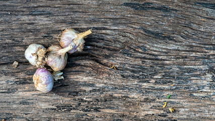 Garlic cloves pile closeup. Garlic clove group on wood rustic table background side view