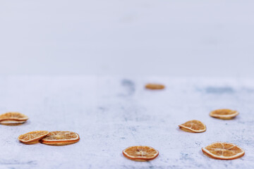 Winter white Christmas background or backdrop with dried orange slices and stars