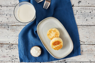 Cottage cheese pancakes with sour cream, flatlay