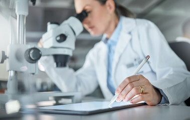 Science research, lab tablet and scientist working on analysis of virus with microscope and writing on technology at work. Medical technician in pharmaceutical development and biotechnology online