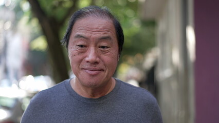 One pensive senior man having an idea breakthrough while walking outdoors. Portrait of a...