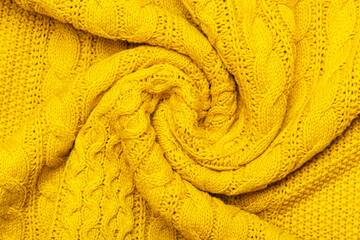 Bright yellow macro photo of textured jersey and knitting of sweater or sweatshirt. Pattern and...