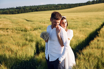 Beautiful sunlight. Couple just married. Together on the majestic agricultural field