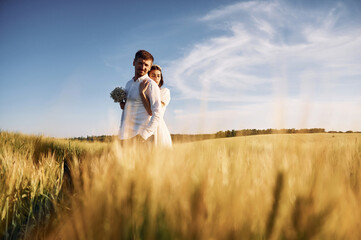 Beautiful sunlight. Couple just married. Together on the majestic agricultural field