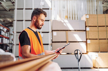 Checking quality of product. Storage worker is in the warehouse