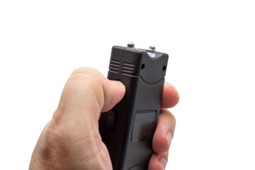 Taser in a man's hand, close-up, isolated white background.