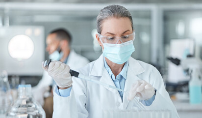 Covid, lab mask and vaccine research woman with medicine analysis test tube in a lab. Medical...