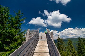 Lookout point at Certova hora with white clouds. Krkonose. Czech Republic.
