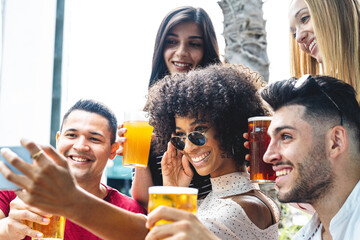 Multiracial friends taking group selfie shot smiling at camera, laughing young people standing outdoor and having fun, cheerful people at pub, having fun concept