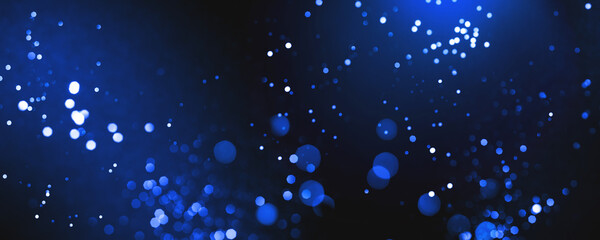 Blue abstract bokeh on dark background. Holiday concept