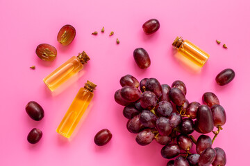 Grape seed oil in bottles with bunch of grapes. Eco cosmetic product