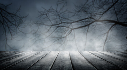 Spooky misty horror halloween background with empty wooden planks, ideal for product placement