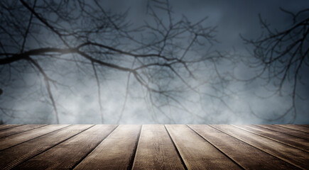 Spooky misty horror halloween background with empty wooden planks, ideal for product placement