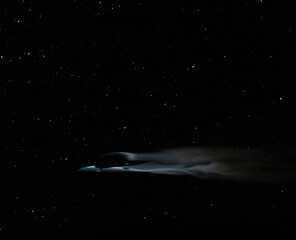 Fast flying saucer moving across a night sky