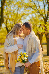 Pregnant woman and man at sunny warm autumn park