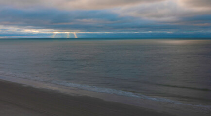 Fototapeta na wymiar Rays of sun peeking through storm clouds at Myrtle Beach