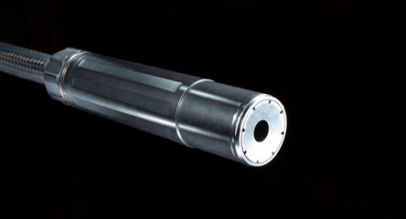 Silencer on a gun barrel with black background