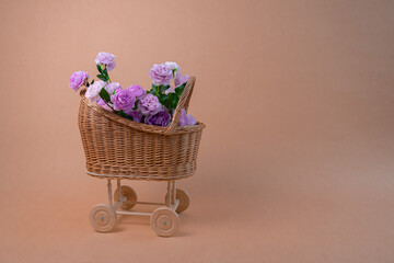 bouquet of pink roses in a wicker basket on a beige background