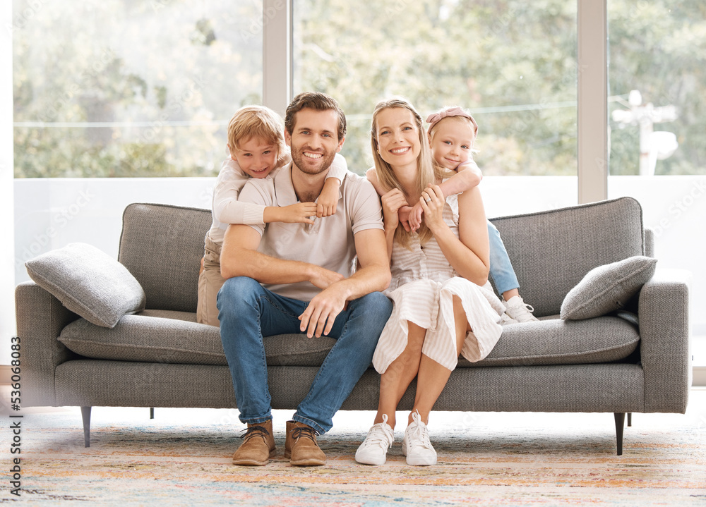 Wall mural Happy, family smile and relax on living room sofa for holiday break together at home. Portrait of white couple and kids relaxing, smiling and enjoying time in happiness sitting on couch in the lounge