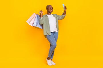 Full body photo of pretty attractive person hold telephone make selfie isolated on yellow color background