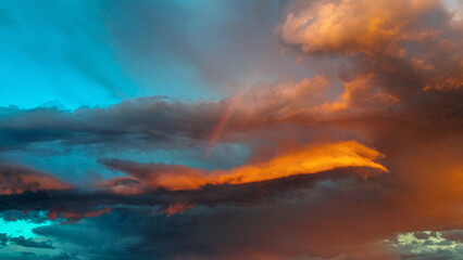 Fototapeta na wymiar Rainbow in dramatic sunset