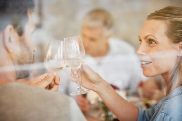 Couple, smile and champagne toast at dinner celebrating in home. Cheers, love and man, woman and sparkling golden wine or alcohol, beverage or drink celebration at party, event or family gathering.