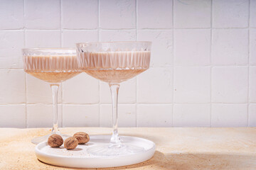 Boozy creamy Brandy Alexander Cocktail with nutmeg. Trendy autumn winter alcohol drink 