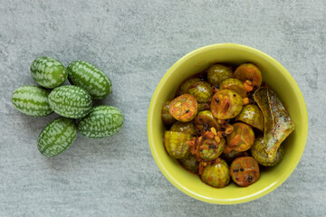 South Indian style pickled cucamelon vegetable in a bowl. Top view.