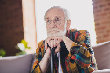 Photo of upset depressed grandpa grey hair head lean walking stick wear casual checkered look eyewear sitting cozy sofa indoors home room - obrazy, fototapety, plakaty