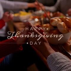 Composition of happy thanksgiving day text over holding hands at table © vectorfusionart