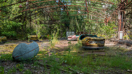 Rusty metal radioactive children's electric cars after explosion fourth reactor Chernobyl nuclear...