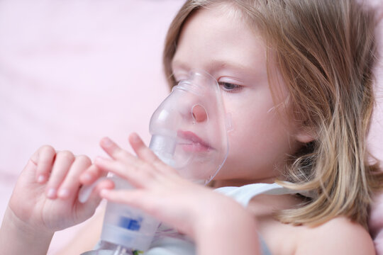 Portrait of child girl with inhaler for asthma