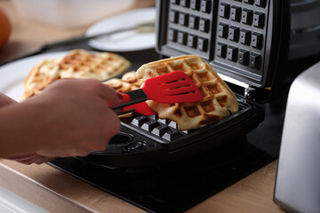 Belgian waffles in waffle iron in kitchen