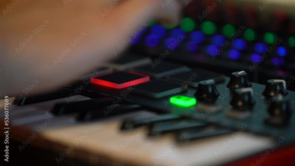 Poster music producing on midi controller keyboard, touch pads create beat and light up