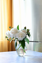 Peonies in a vase. white peonies in florist hand. The florist girl gathered a bouquet. Beautiful spring white flowers.