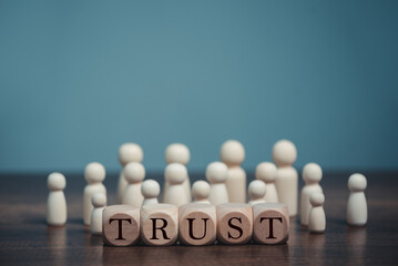 Wooden blocks with the word Trust,  Trust relationships between, reliable partner, business...