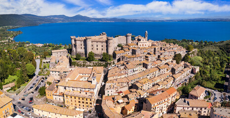 Medieval castles of Italy - Castello Orsini-Odescalchi in Bracciano town and lake. Aerial drone...