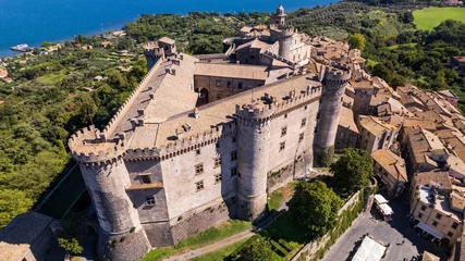Gordijnen Medieval castles of Italy - Castello Orsini-Odescalchi in Bracciano town and lake. Aerial drone view. Lazio region © Freesurf