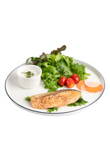 Fried salmon steaks with vegetables on white background isolated