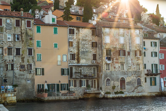 old, historic buildings of the historic old town of Rijeka from the sea at sunset
