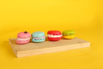 macaroons on a wooden isolated on yellow background 